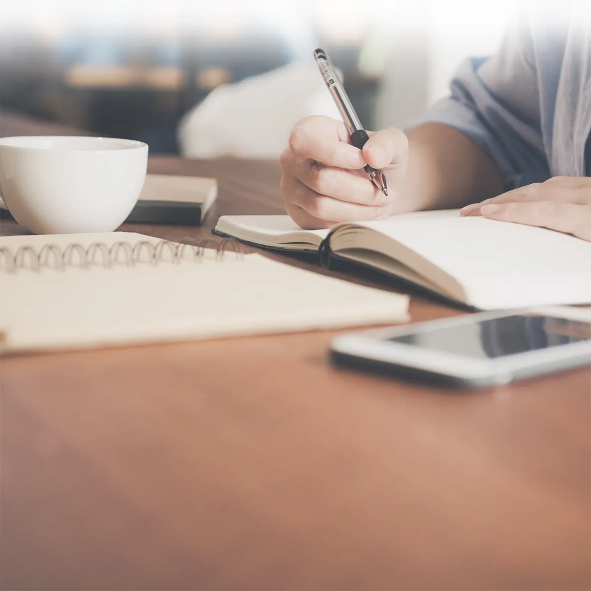 coffee and somebody writing a list of what cryptocurrencies to buy next